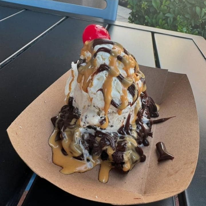 Brownie sundae with ice cream, chocolate and caramel sauce, and a cherry
