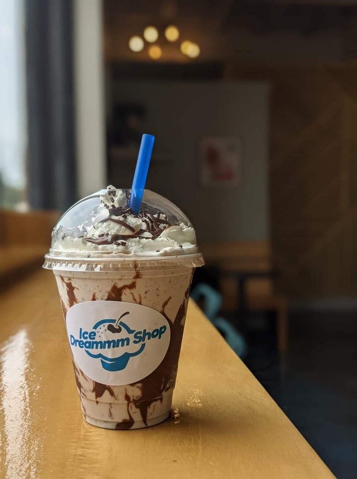 Handspun milkshake with whipped cream and chocolate drizzle in an Ice Dreammm Shop cup