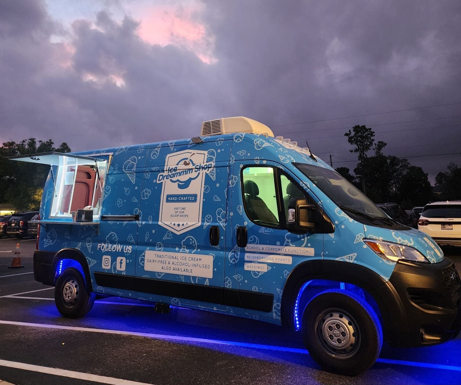 Ice Dreammm Shop ice cream truck lit with blue lights at dusk
